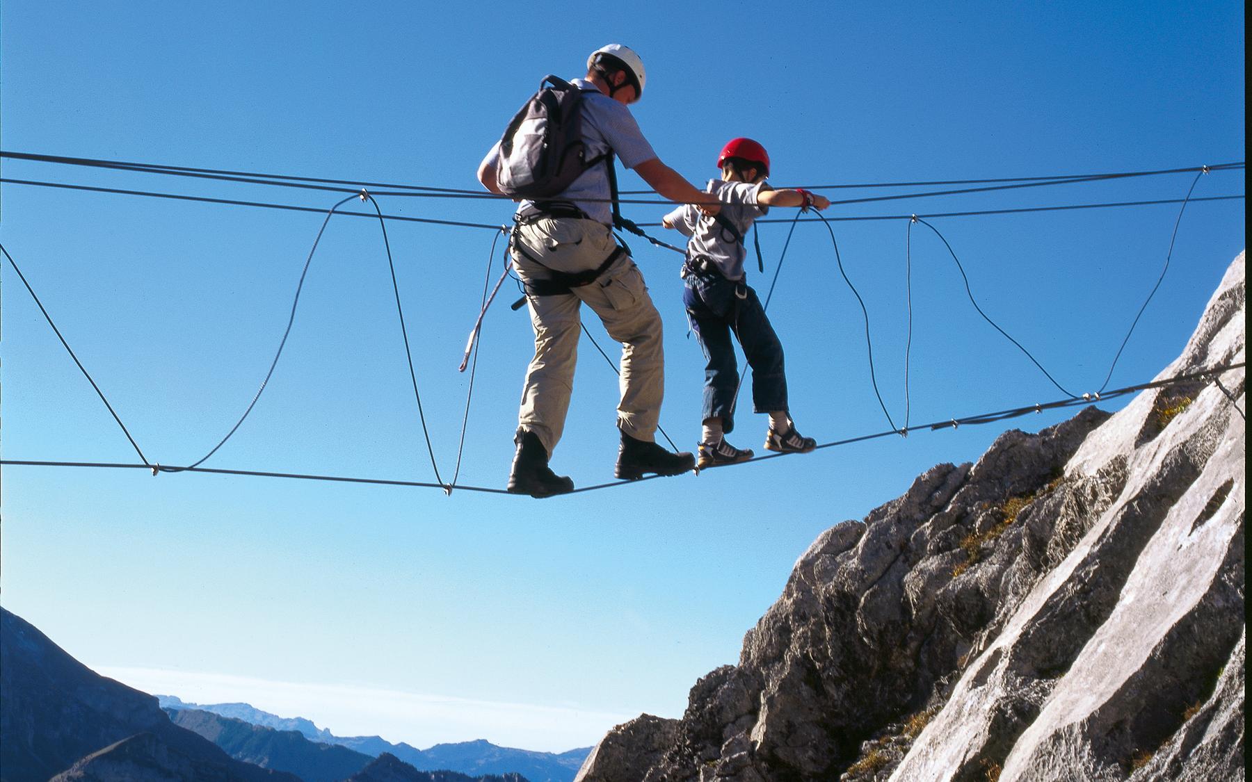 Father and son on the three-cable bridge.