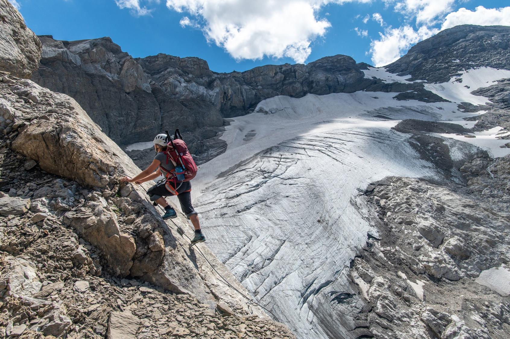 Eine nicht-englische Dame auf der Via Ferrata. Dahinter der Glacier de Prapio.